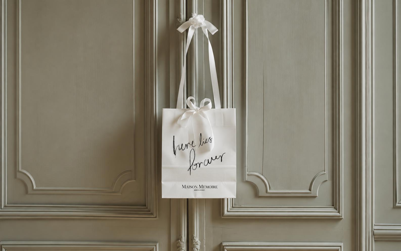 Maison Mémoire gift bag with an ivory ribbon and the words here lies forever